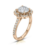 Perspective angle of a 3 carat round lab grown diamond vintage bloom halo ring crafted in 14k rose gold.