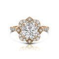 Top down view of a 3 carat round lab diamond vintage style floral halo ring set in rose gold with accent pavé diamonds.