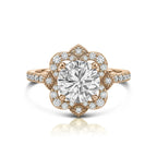 Top down view of a 3 carat round lab diamond vintage style floral halo ring set in rose gold with accent pavé diamonds.