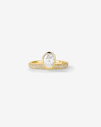Front view of a 1.5 CT oval lab grown diamond engagement ring featuring a yellow gold bezel setting and multi-row micro pavé diamond band against a clean background.