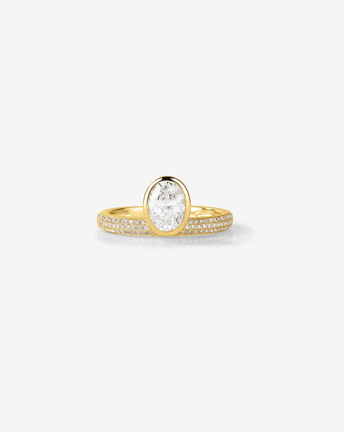 Front view of a 1.5 CT oval lab grown diamond engagement ring featuring a yellow gold bezel setting and multi-row micro pavé diamond band against a clean background.