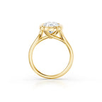 Complete side view of a yellow gold engagement ring displaying the intricate interwoven bridge and cathedral shoulders holding an oval lab diamond.