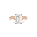 Front view of a 3 CT emerald cut lab created diamond engagement ring in rose gold featuring intricate vintage etched side shoulders.