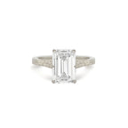 Front view of a 3 CT emerald cut lab diamond solitaire ring set in white gold with a hand-engraved vintage shank.