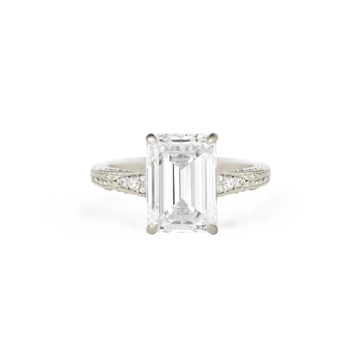 Front studio view of a 3 CT emerald cut lab diamond engagement ring in white gold featuring milgrain engraved shoulders and side diamonds.