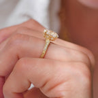 Side profile showing the hand-engraved band and filigree basket setting of a 2 CT oval diamond ring.