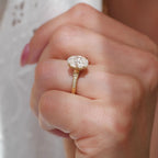 Close-up of a 2 CT oval lab diamond engagement ring showing tapered milgrain shoulder accents.