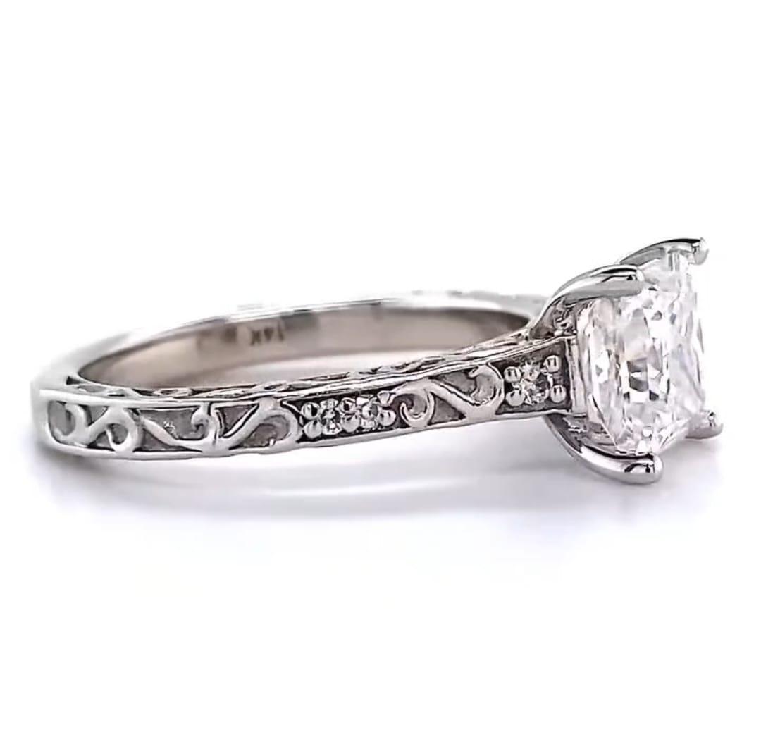 Side profile of a 2.5 CT princess cut lab grown diamond ring showing intricate filigree scroll engraving and accent diamonds set in 14K white gold.
