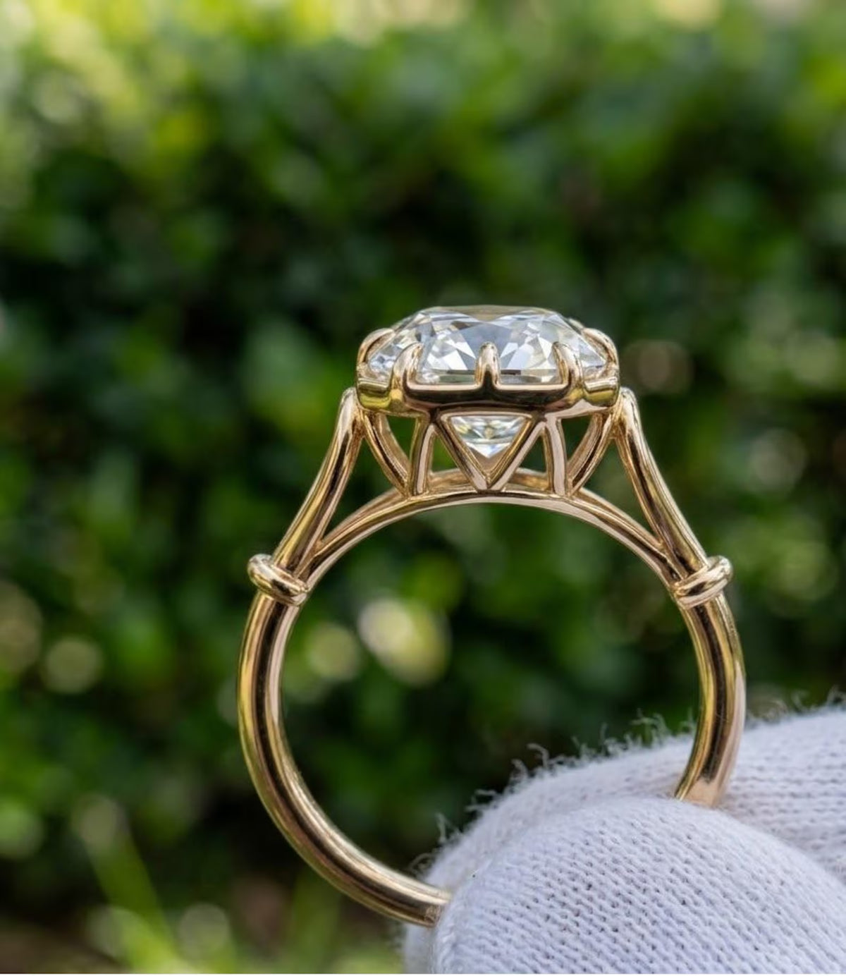 Straight-on side view of 3 carat Asscher cut lab created diamond solitaire showing the cathedral setting height and cuff detail on yellow gold band.