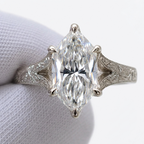 Direct top view of a 4 CT marquise cut lab grown diamond ring with 6-prong setting and hand-carved white gold band.