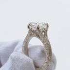Detailed side view highlighting the intricate milgrain and vintage floral engraving along the white gold ring shank.