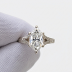 Straight top-down view of 4 CT marquise cut lab created diamond featuring brilliant facets and split shoulder engraved details.