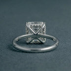 Underside view of a 3 carat Asscher cut lab diamond ring showing the structural X-shaped bridge gallery and hidden halo detailing.