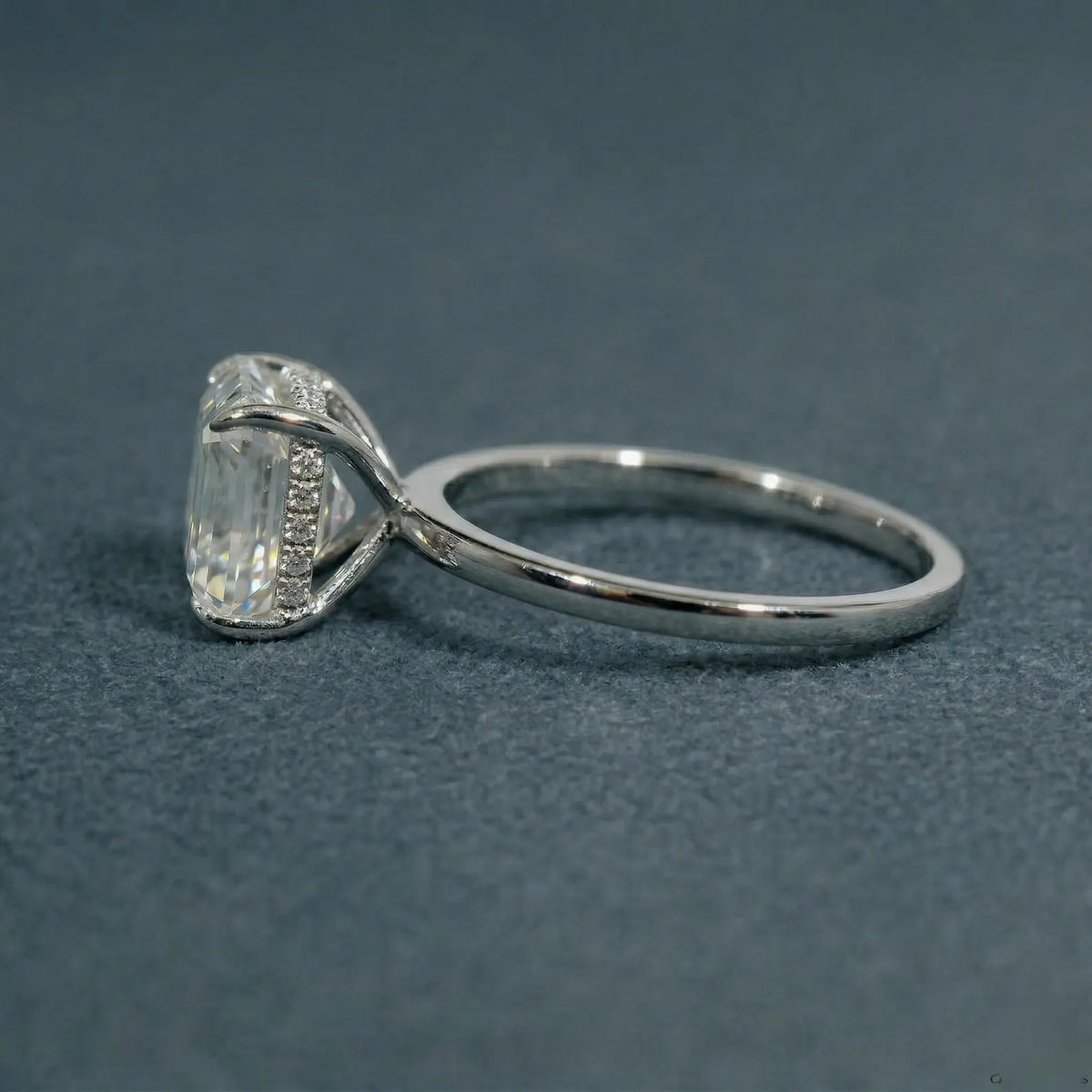Side profile view of a 3 carat Asscher lab grown diamond engagement ring displaying the slim polished band and raised center stone.