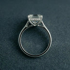 Direct side elevation of an Asscher cut lab diamond engagement ring showcasing cathedral shoulders and a sparkling hidden halo collar.