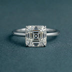 Direct top-down view highlighting the square step-cut facets and four-prong setting of a 3 carat Asscher cut lab grown diamond.