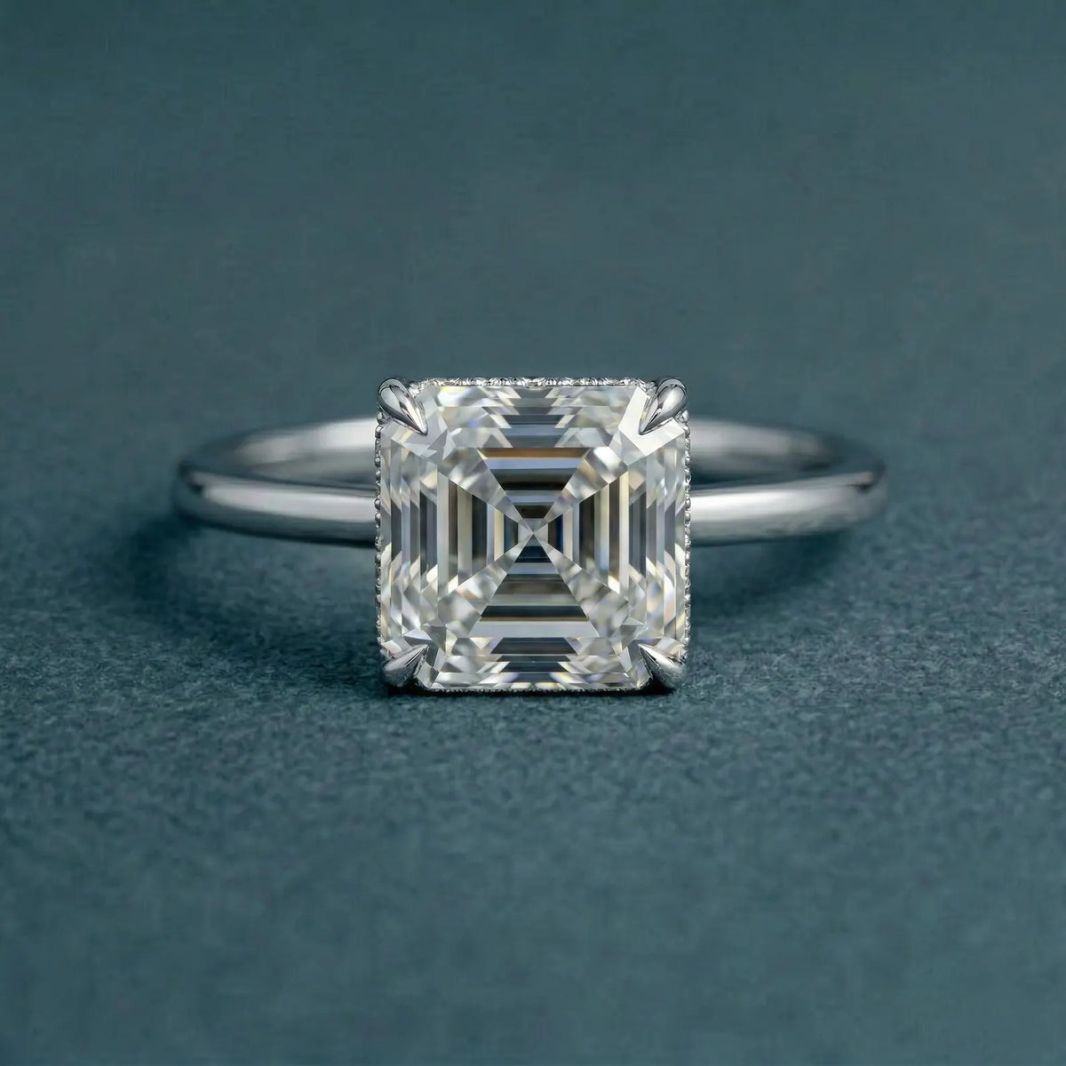 Direct top-down view highlighting the square step-cut facets and four-prong setting of a 3 carat Asscher cut lab grown diamond.