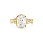 Front view of 3 CT elongated cushion lab diamond ring in 14k yellow gold with flower engraved band and milgrain border.