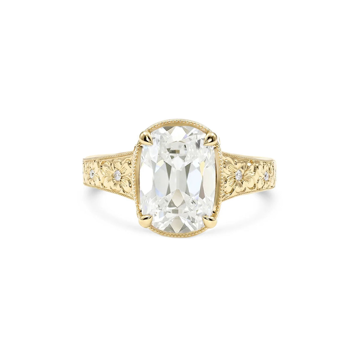 Front view of 3 CT elongated cushion lab diamond ring in 14k yellow gold with flower engraved band and milgrain border.