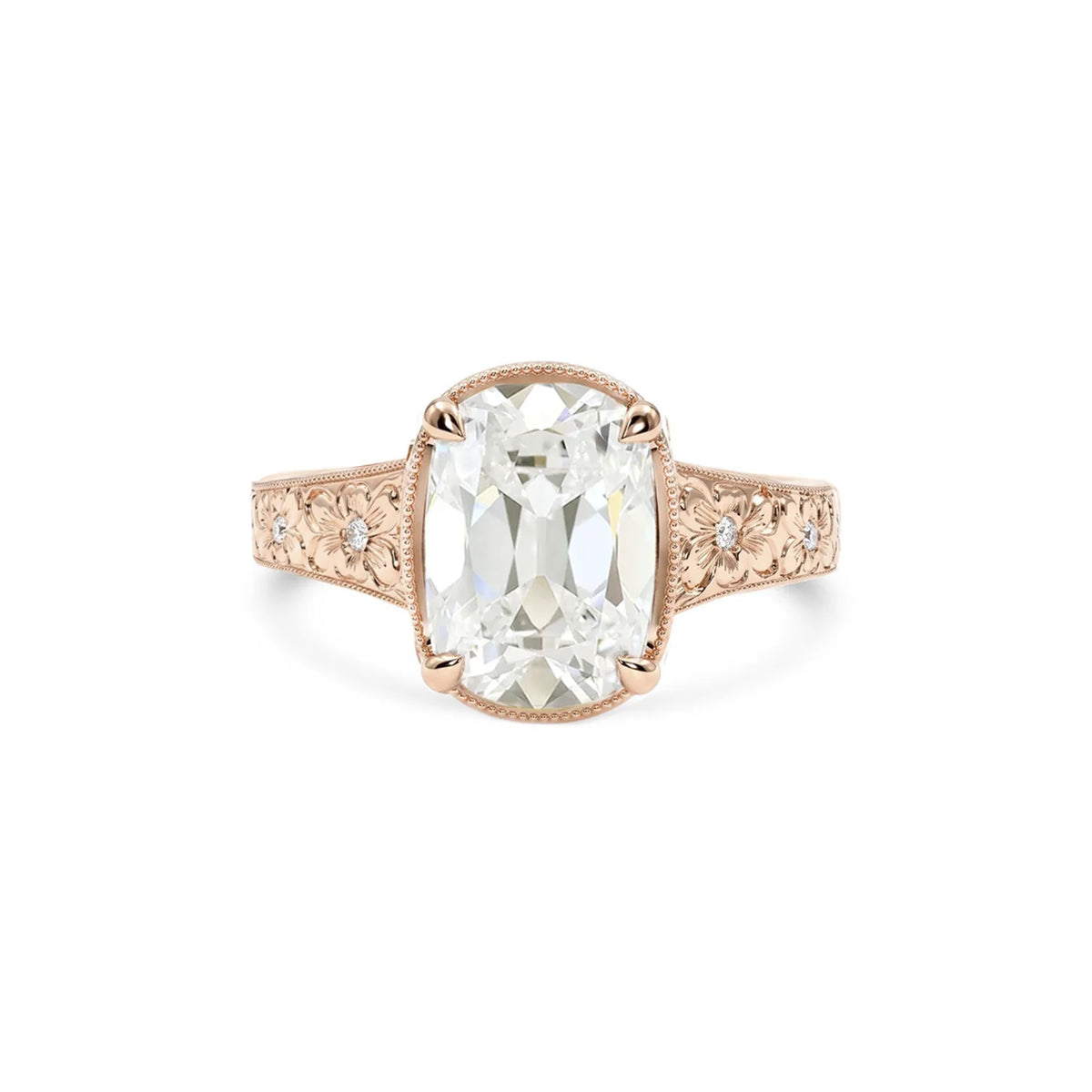 Rose gold 3 CT elongated cushion cut lab diamond engagement ring with floral hand-engraved band.