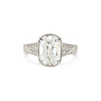 White gold 3 carat elongated cushion lab created diamond ring with vintage floral motif shank.