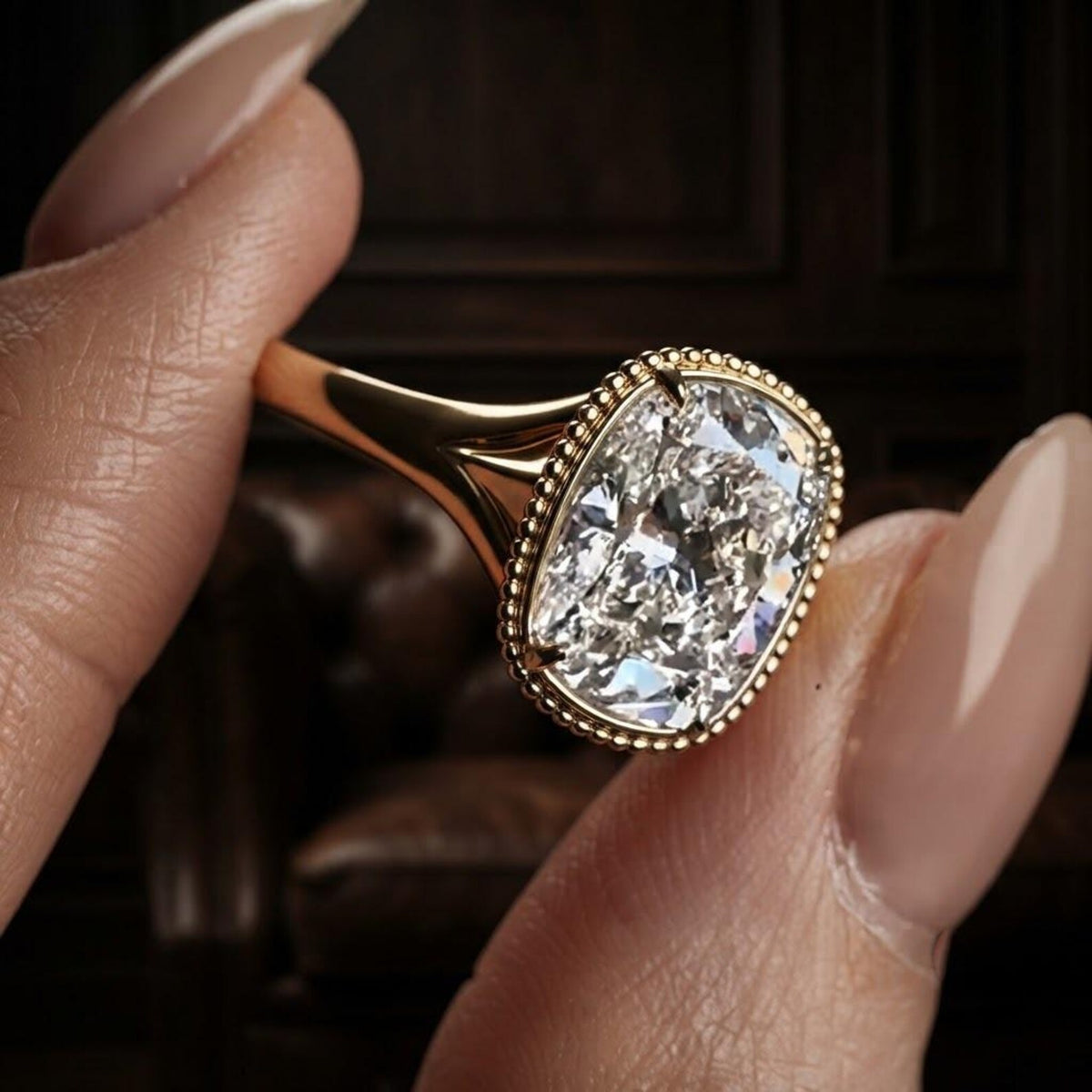 Direct side profile of a yellow gold engagement ring showing the smooth split shank and elevated cushion cut lab diamond setting.