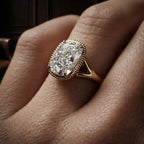Angled perspective view of a 3 carat elongated cushion cut lab grown diamond engagement ring worn on a finger.