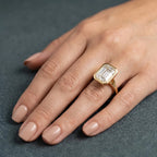 On-hand view of a 3 CT emerald cut lab grown diamond full bezel engagement ring in yellow gold.