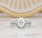 2 CT oval lab grown diamond engagement ring with matching filigree wedding band set in white gold with milgrain edging.
