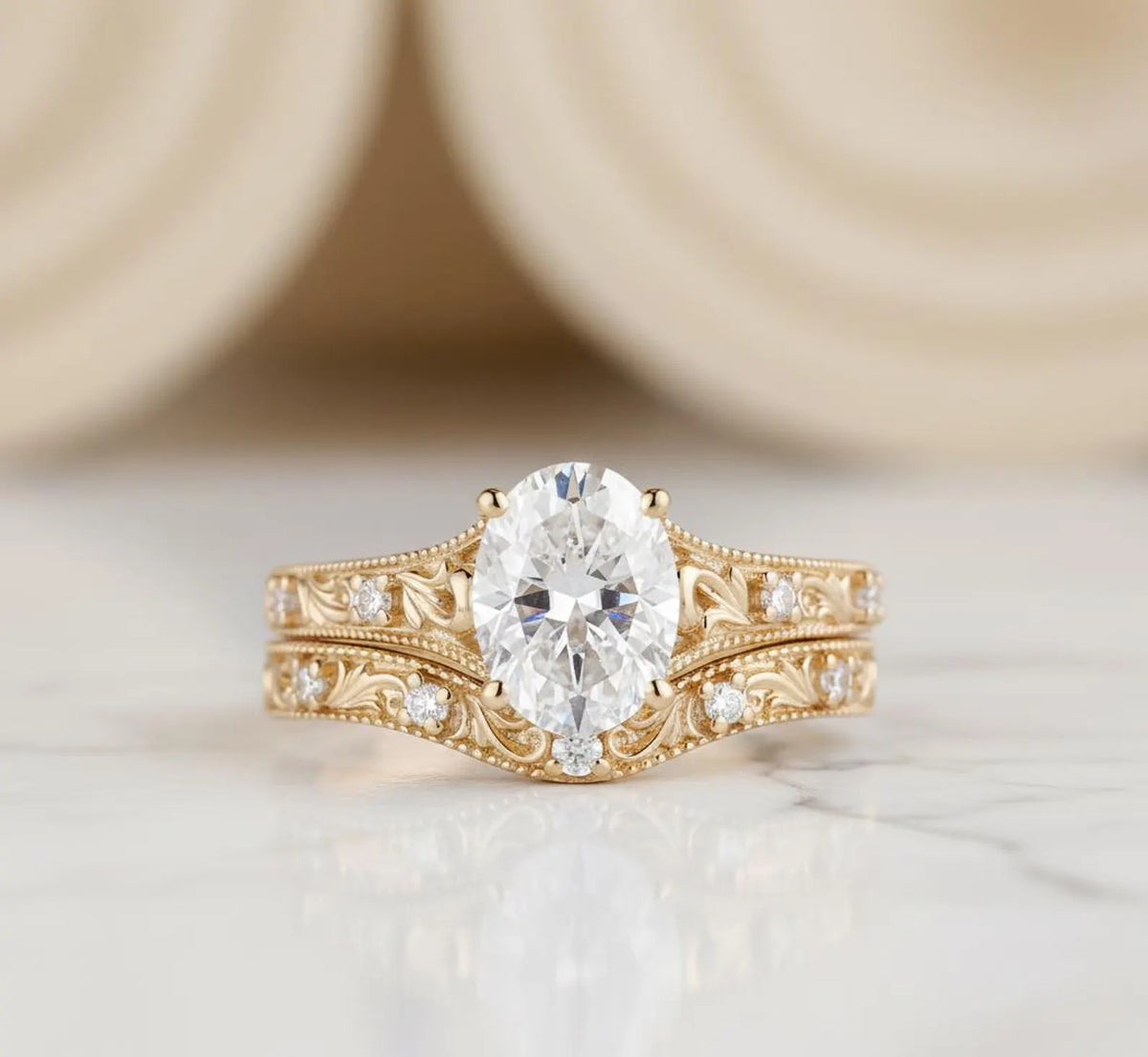 Vintage style 2 carat oval lab created diamond engagement ring and carved band stack in 14k yellow gold.