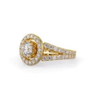 Side perspective view highlighting the sparkling halo and double pavé split shoulders on a yellow gold ring.