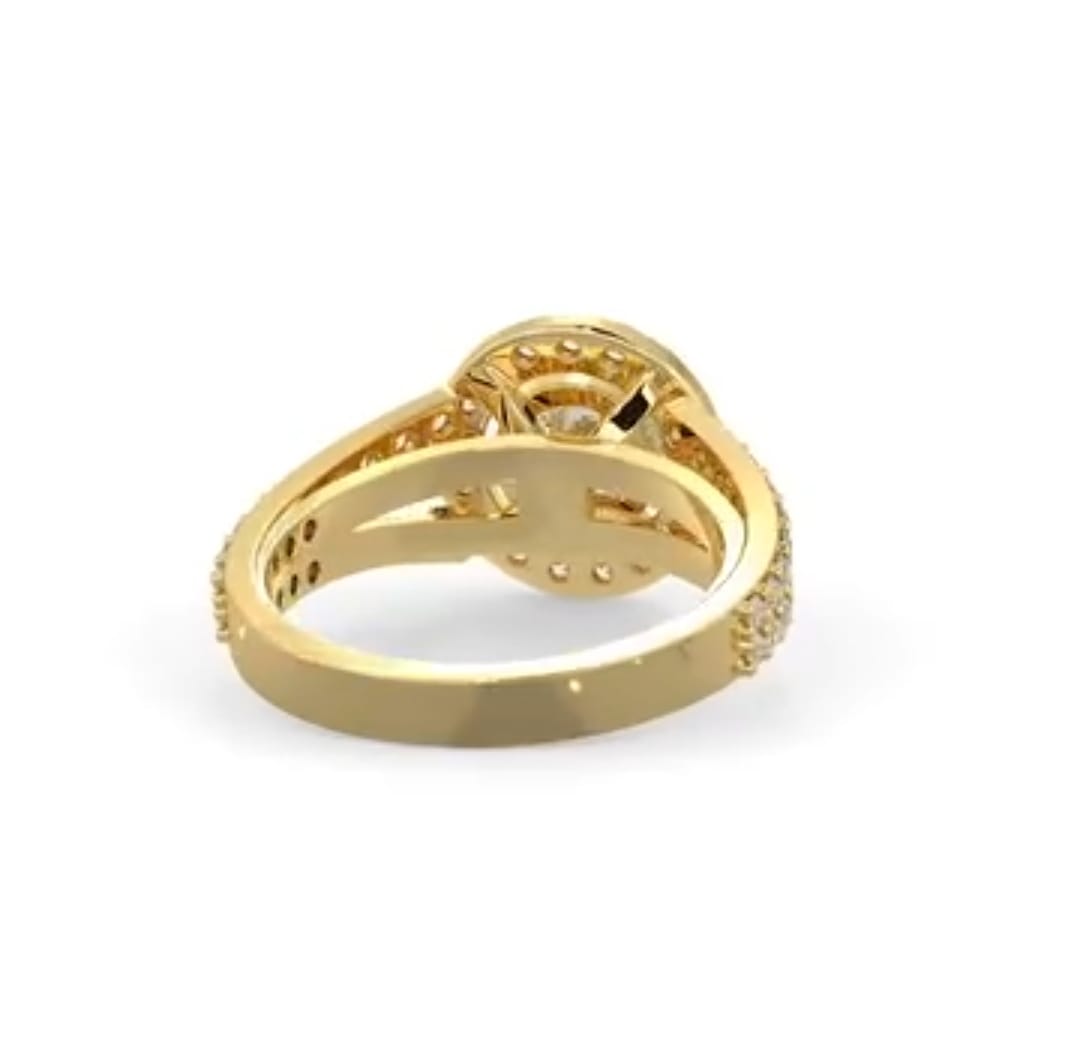 Under-gallery view showing the openwork setting and inner band of a yellow gold halo diamond engagement ring.