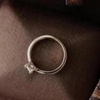 Top-down view of a 2 carat emerald cut lab diamond ring showing four-prong setting and solid gold band.