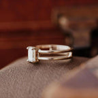 Side profile view of modern emerald cut lab grown diamond ring with open double-row band architecture.
