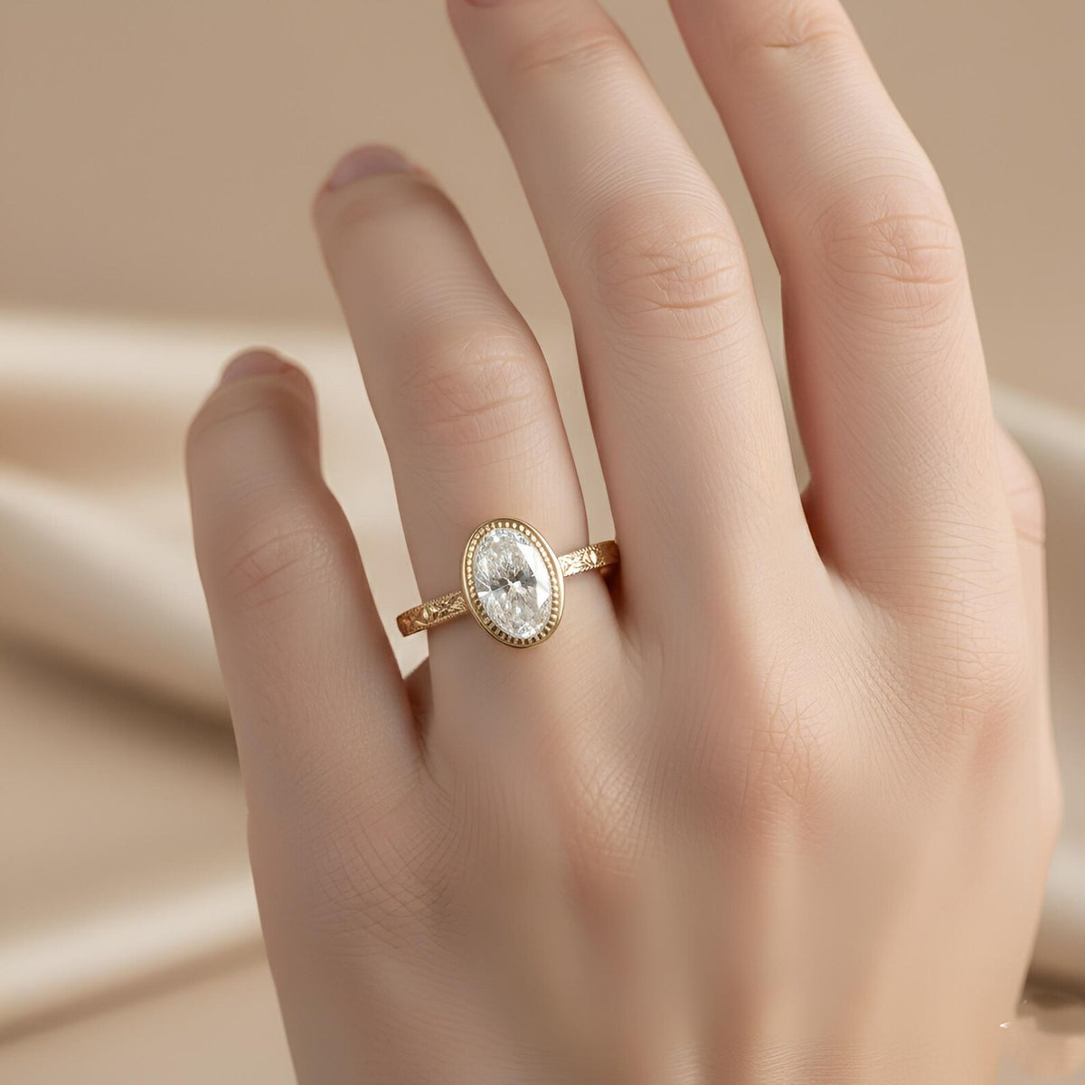 On-hand modeling view of a 2 CT oval lab grown diamond bezel ring in 14k yellow gold with engraved band.