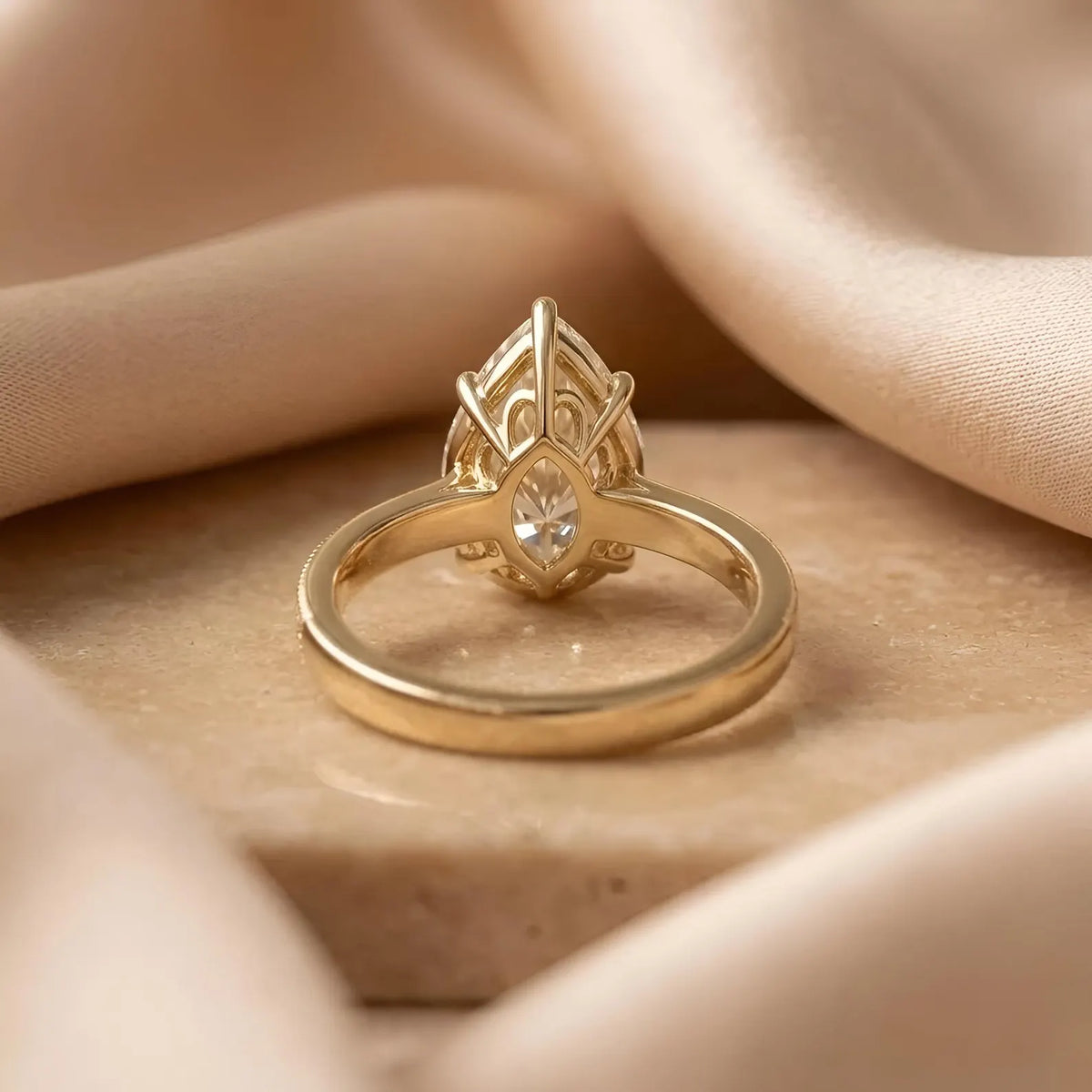 Underside gallery view showing intricate cathedral basket setting supporting a 3 CT pear lab diamond.