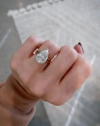 On-hand model view of a 4 CT pear lab grown diamond engagement ring with split shank.