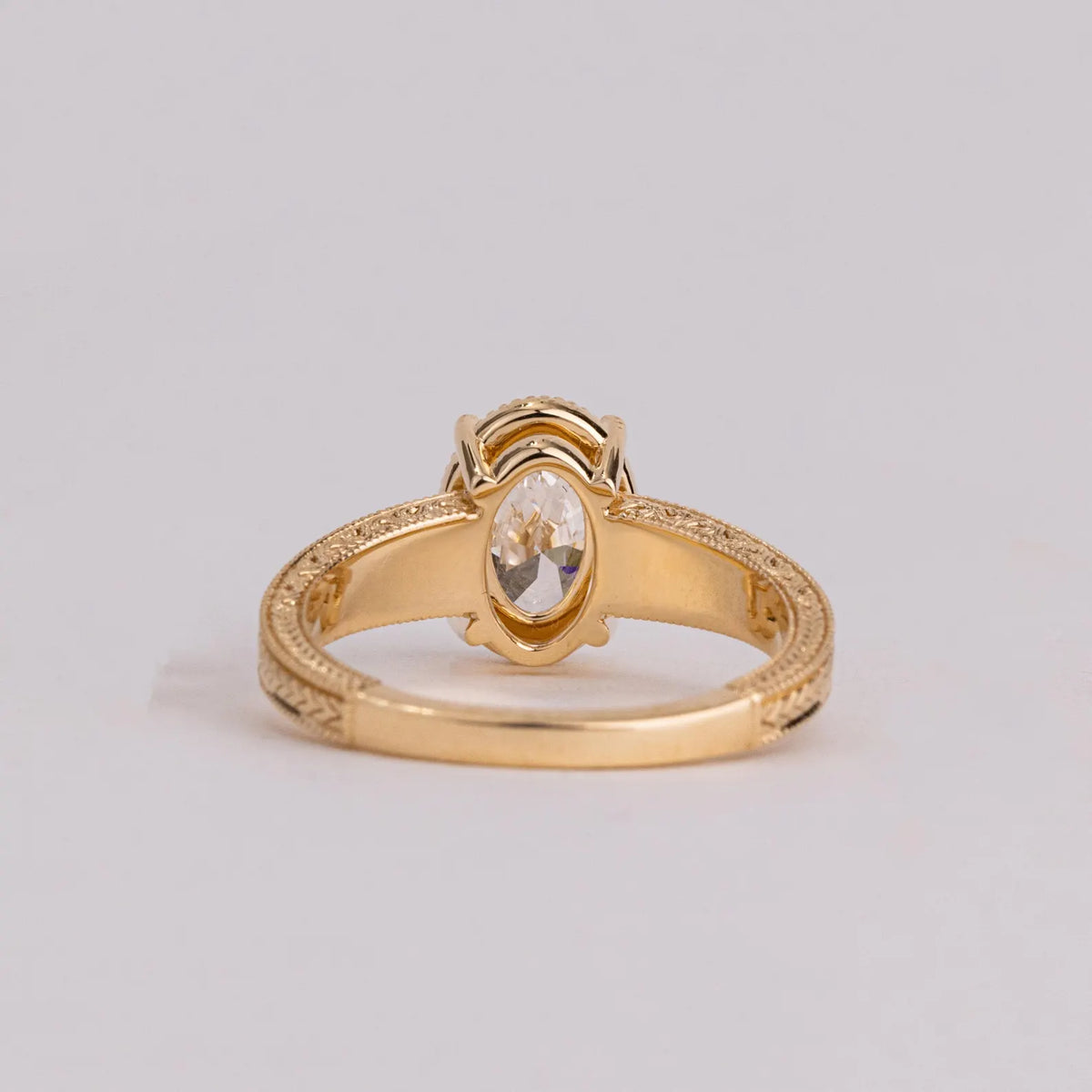 Back view showing the undergallery basket and interior band of a 2 CT oval lab diamond ring.