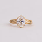 Frontal close-up view of a 2 CT oval lab created diamond solitaire ring with milgrain trim and engraved band.