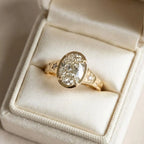 3 carat oval lab grown diamond bezel engagement ring presented inside an ivory velvet ring box.