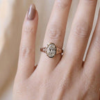 Model wearing a 3 carat oval lab grown diamond engagement ring on finger showcasing scale and fit.
