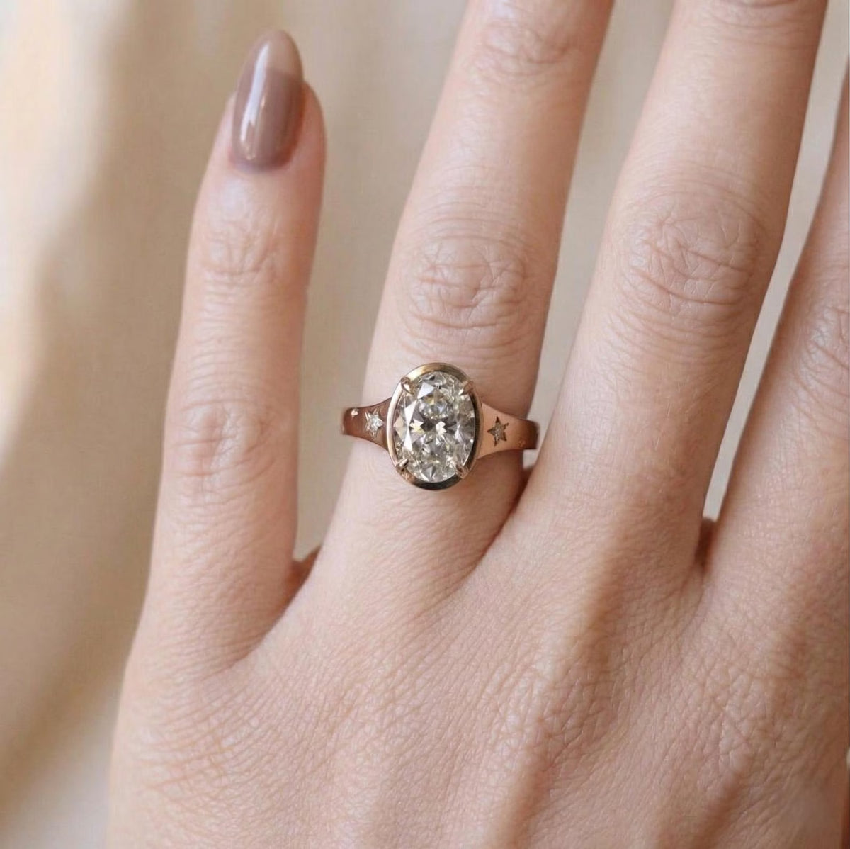 Model wearing a 3 carat oval lab grown diamond engagement ring on finger showcasing scale and fit.