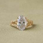 Front top-down view highlighting the brilliant oval lab grown diamond and intricate gold filigree band details.