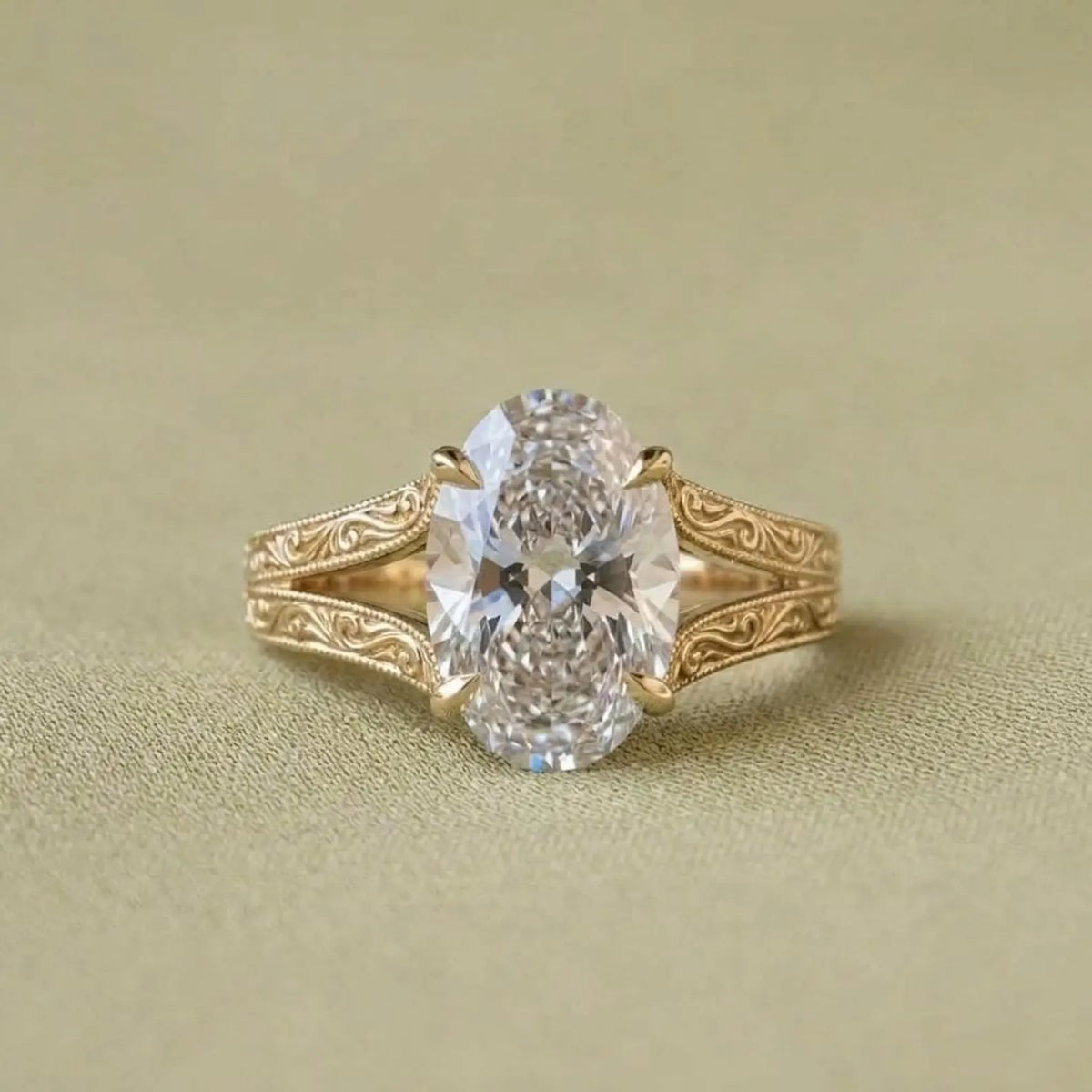 Front top-down view highlighting the brilliant oval lab grown diamond and intricate gold filigree band details.