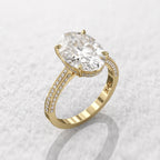 Top angle view of a 5 carat oval lab grown diamond engagement ring in yellow gold with a pave band.