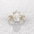 Direct top-down view of the 5 carat oval diamond center stone on a reflective snowy background.