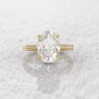 Direct top-down view of the 5 carat oval diamond center stone on a reflective snowy background.
