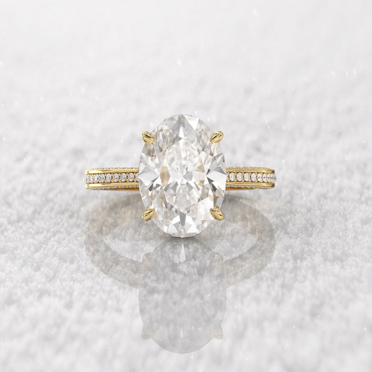 Direct top-down view of the 5 carat oval diamond center stone on a reflective snowy background.