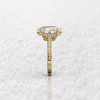 Side profile view highlighting the hidden halo and high-set prongs of the oval diamond ring.