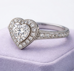 Angled perspective showcasing the sparkling halo and pave band resting on a soft surface.